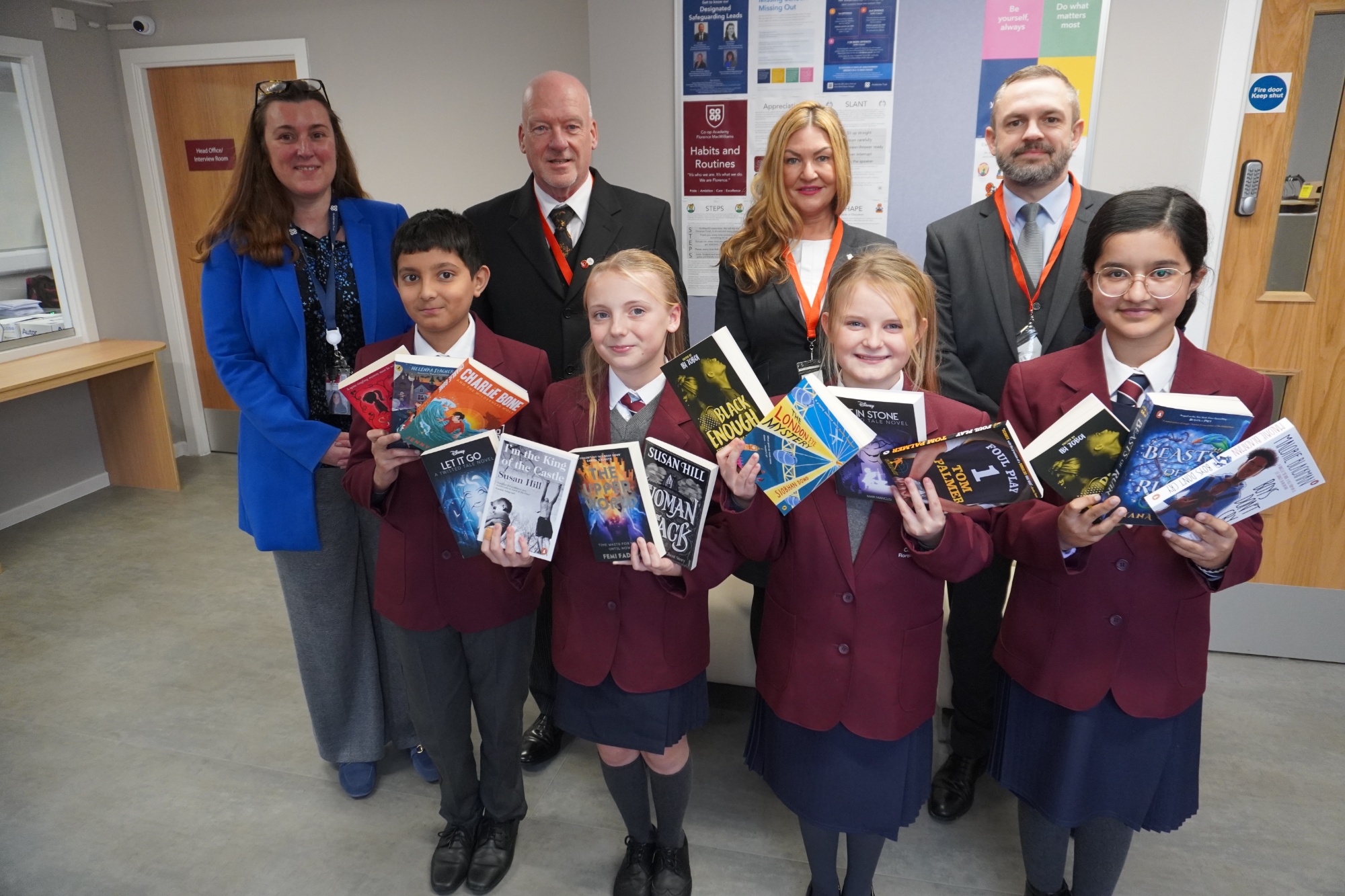 Academy staff and students are presented with books by staff from Co-op Funeralcare